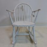 A 20th century white painted Ercol child's rocking chair