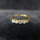 A Victorian 18ct yellow gold and platinum ring set to the centre with five, graduated old-cut