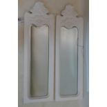A pair of white painted carved mirrors with bevelled plates, 83 x 25cm