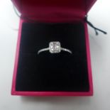 A boxed 18ct white gold diamond cluster ring of 0.30 carats to diamond-set shoulders, Size: N, 1.9g