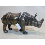 A bronzed metal rhino, H.26 L.50cm