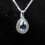A boxed 18ct white gold pear-shaped aquamarine and brilliant-cut diamond pendant on an 18ct white