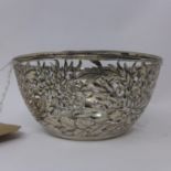 A rare Chinese pierced silver bowl by Yu Chang, the sides decorated with chrysanthemums and cash