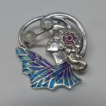 A sterling silver brooch/pendant in the Art Nouveau style set with enamel ruby and moonstones, 3.5 x