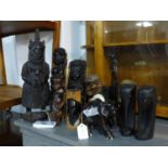 A collection of tribal carvings to include a carved calamander example