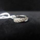 A 9ct white gold and diamond swirl shaped 9 stone ring