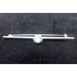 An antique platinum fronted 9ct white gold, opal and diamond cluster bar brooch, in box