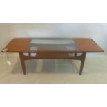 A 20th century teak G-plan coffee table with glass top, H.44 W.137 D.51cm