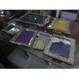 A collection of six silver mounted picture frames of varying sizes, with hallmarks for London,