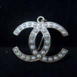 A Chanel style pendant/brooch, set with faux pearls, H.3.2 W.4cm