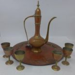 A Middle Eastern enamelled brass tea set, with hot water pot, six cups and circular tray,