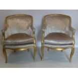 A pair of Louis XV style giltwood chairs, with velour upholstery, on cabriole legs