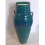 A Persian green and turquoise glazed Sharab wine vessel, H.90cm