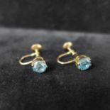 A pair of blue zircon earrings with gold set screw back