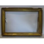 A late 19th/early 20th century gilt wood picture frame, outer - 81 x 120cm inner - 63 x 98cm