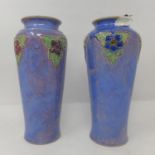 A pair of early 20th century Royal Doulton vases, decorated with stylised flowers, with impressed