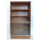 A 20th century 'Minty, Oxford' teak bookcase, with adjustable shelves above 2 sliding glass doors,