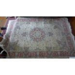 A Persian Tabriz style rug, central floral medallion on a cream ground within stylised floral