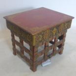 An early 20th century Chinese red lacquered and gilt painted folding table, H.33 W.39 D.33cm