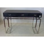 A campaign style 2 drawer console table, raised on chrome base, H.79 W.120 D.45cm
