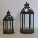 Two 20th century hexagonal storm lanterns, with pierced floral decoration, H.49cm; and H.46cm