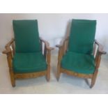 A pair of early 20th century oak steamer chairs, with green upholstered cushions