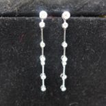 A pair of 18ct white gold and diamond earrings, with 5 stage drop