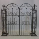 A contemporary metal garden gate, with pierced bird and scrolling design, H.121cm