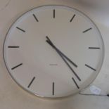 A Karlsson wall clock, the round white dial with baton markers, signed to dial, battery operated,