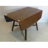 A 20th century Ercol drop leaf dining table