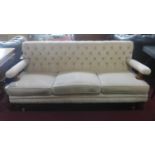 A Victorian sofa with cream button back suede upholstery, on turned legs and castors, H.74 W.167 D.