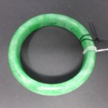 A Chinese jadeite bangle, internal diameter 6.1cm