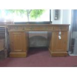 A 20th century walnut pedestal desk, with 2 short and 1 long drawer above two cupboard doors, on