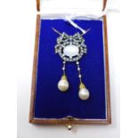 A boxed yellow gold necklace set with a central oval moonstone framed by pearls in a bow and
