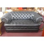 A Chesterfield black leather sofa and matching armchair
