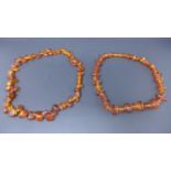 2 natural Latvian vintage amber bead necklaces of polished pebble form, L: 50cm and 40cm, Gross: 90g