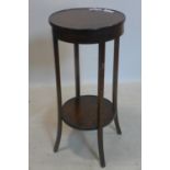 A 20th century oak two tier jardiniere, with circular tops on outswept legs, H.79cm Diameter 37cm