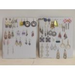 A collection of costume jewellery earrings arranged over 2 boards