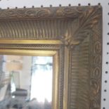 A large gilt mirror with bevelled glass plate, 144 x 204cm