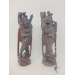 A pair of early 20th century Chinese carved hardwood figures, with silver wire inlay, H.29cm