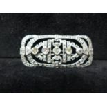 An Edwardian platinum and brilliant-cut diamond brooch of pierced rectangular form set to the centre