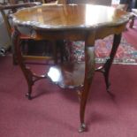 A 20th century mahogany two tiered occasional table, with shell and C-scroll decoration to edge of