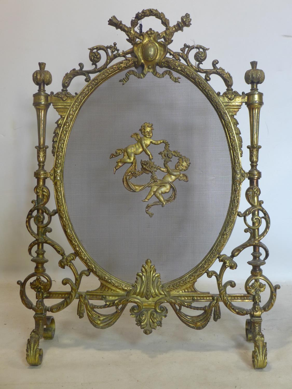 A 19th century ornate ormolu fire guard, H.89 W.66cm