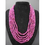 A 5-strand necklace composed of polished spherical natural ruby beads, L: 75cm, 120g, Ruby bead: 5mm