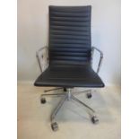 An Eames style swivel desk chair