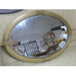A 19th century oval giltwood mirror, with bevelled oval plate within beaded border and ribbed frame,