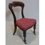 A Victorian mahogany dining chair, with floral upholstered seat, on turned legs and castors