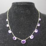 A Victorian 9ct yellow gold and graduated amethyst necklace set with 9 faceted amethysts on a fine