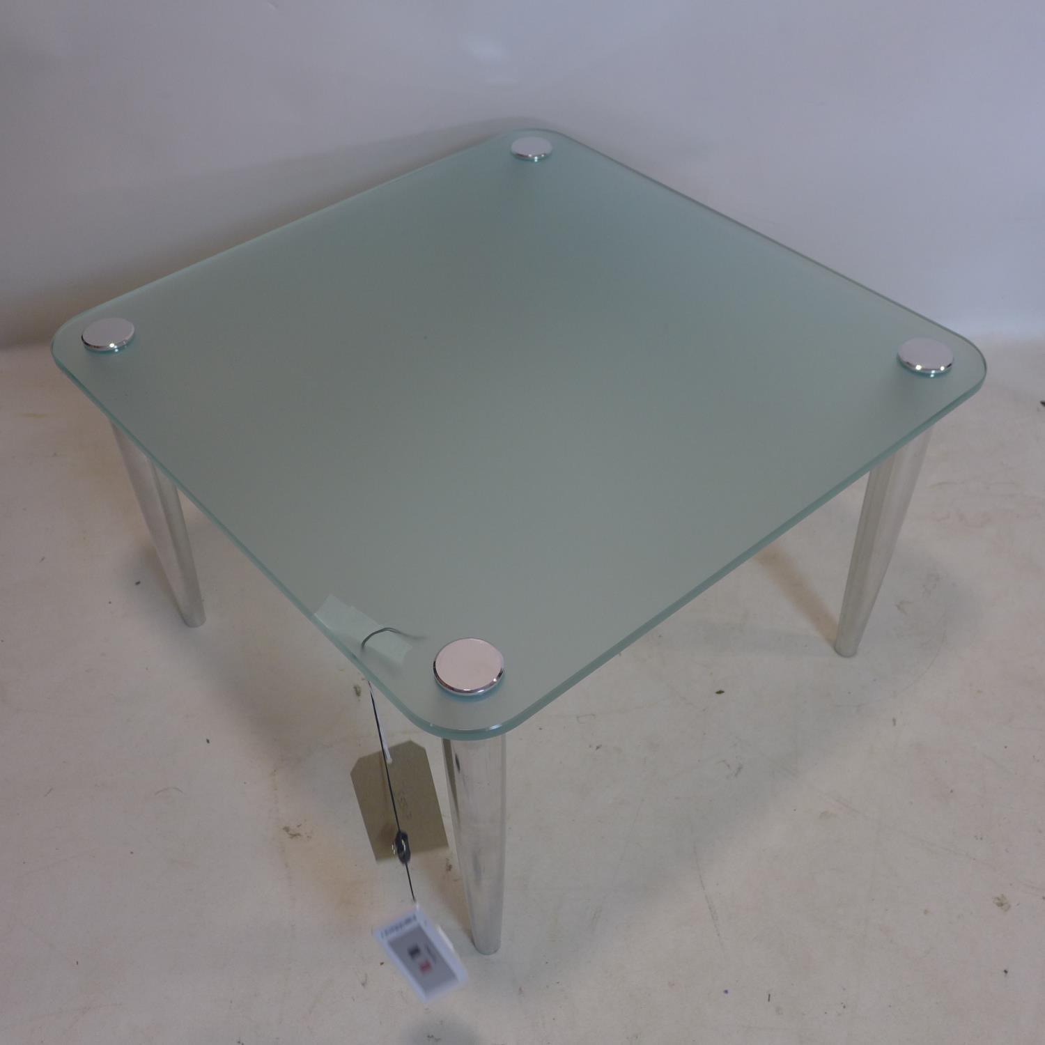 A contemporary coffee table with frosted square glass top, raised on chrome legs, H.41 W.66 D.66cm