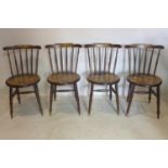 A set of four 20th century oak farmhouse stick back dining chairs